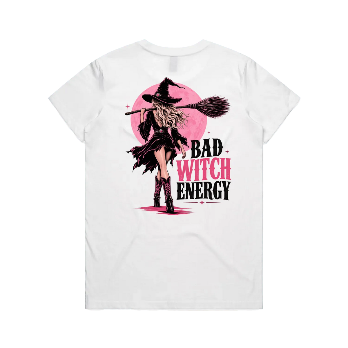 A white short-sleeve t-shirt shown from the back, featuring a graphic print of a witch with a broomstick in front of a pink moon, with the text 'BAD WITCH ENERGY' in black and pink.